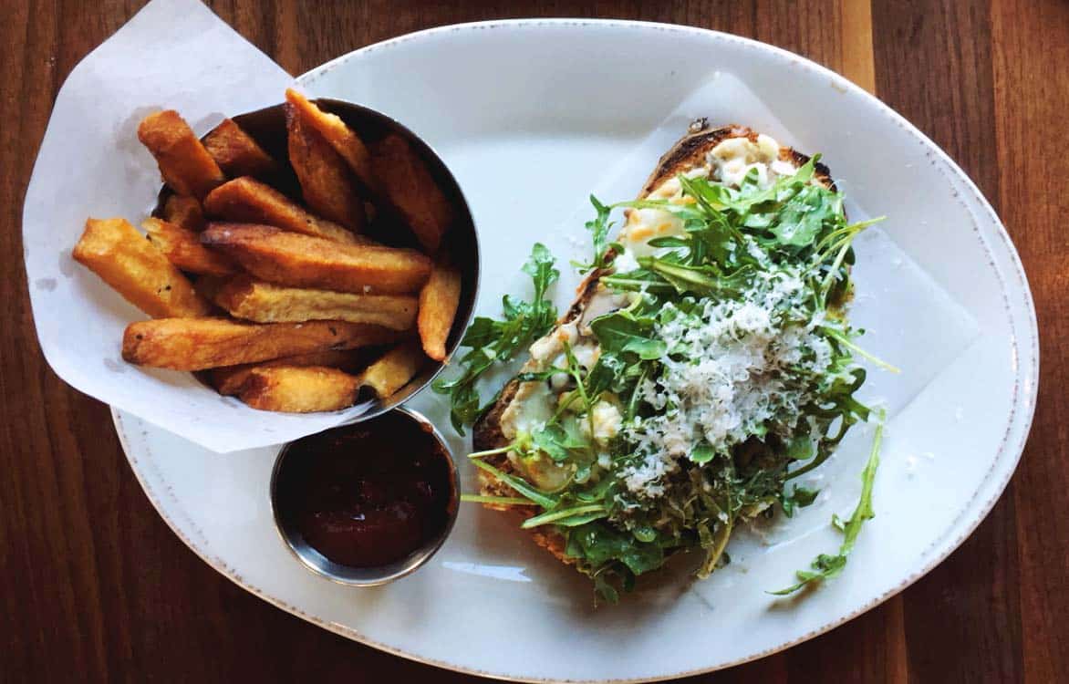 The mushroom tartine ($11 on the lunch menu): hummus, grilled mushrooms, mozzarella, avocado, arugula, and parmesan with a side of batatas fritas.