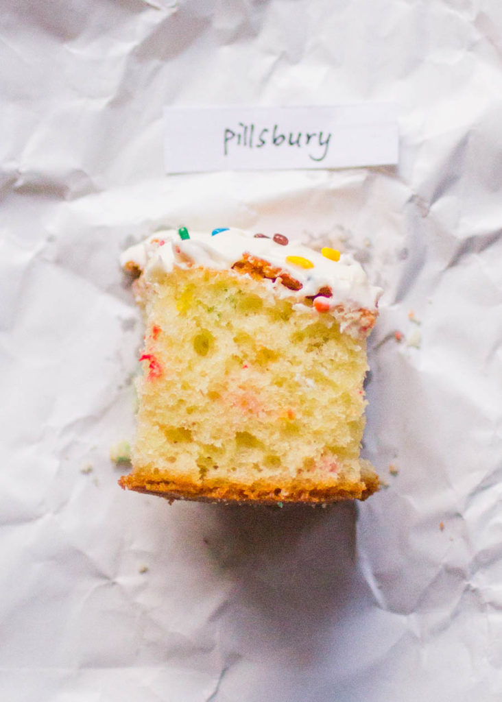 Single slice of Pillsbury sprinkle cake on white parchment paper