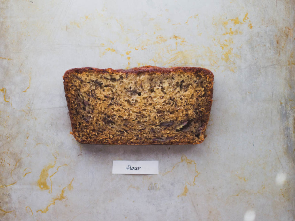 Slice of easy banana bread loaf on baking pan -  Recipe by Flour Bakery
