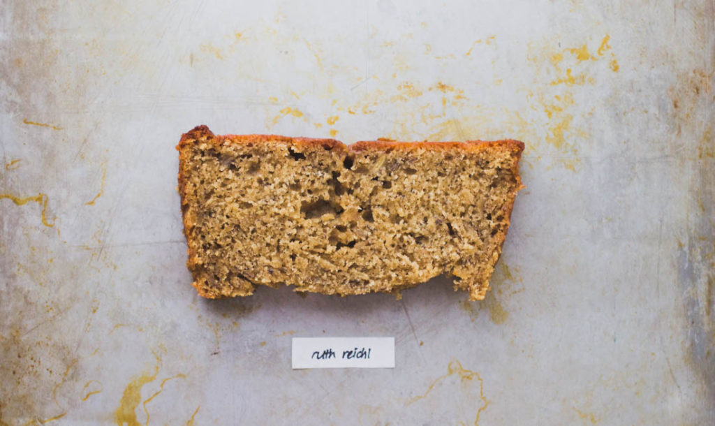 A slice of coarse crumbed banana bread on baking tray - Recipe by Ruth Reichl