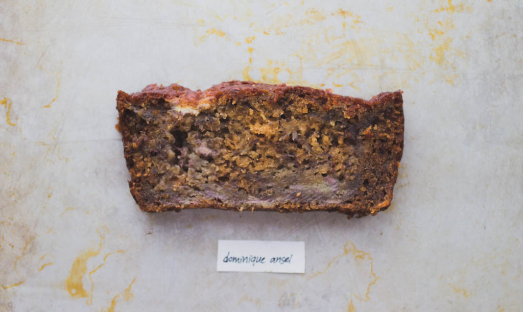 Slice of soft, dark brown banana bread on baking tray - Recipe by Dominique Ansel