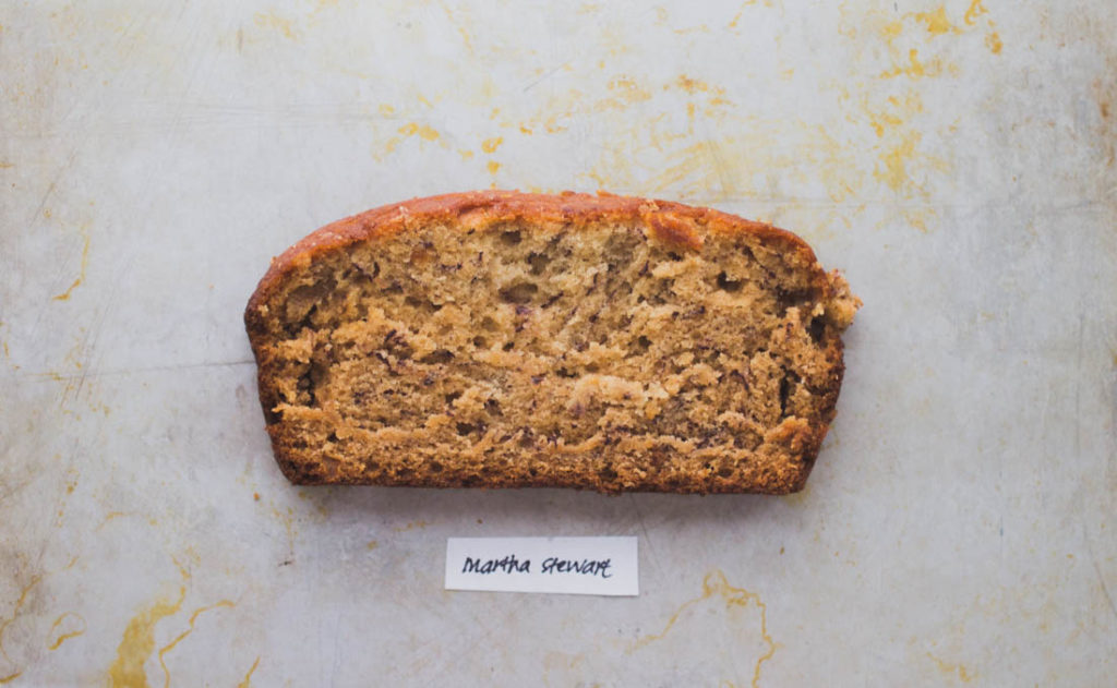 Slice of easy banana bread with a light fluffy crumb on baking tray - recipe by Martha Stewart
