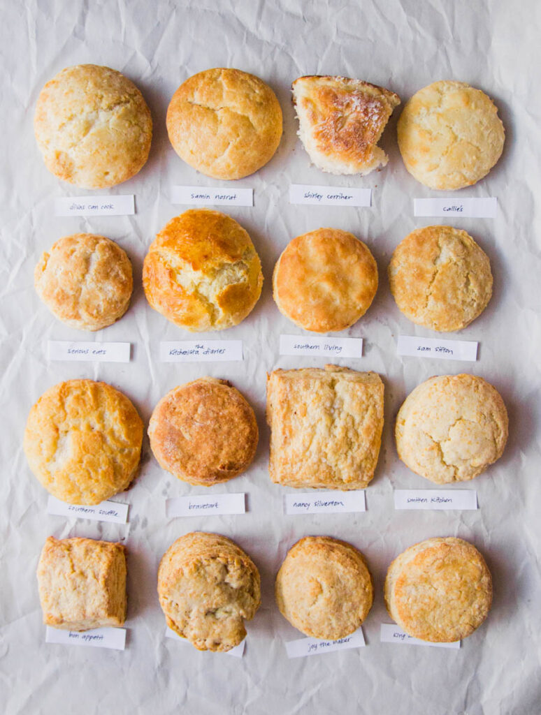 16 biscuits lined in rows of 4 up on white parchment paper for best biscuit recipe bake off
