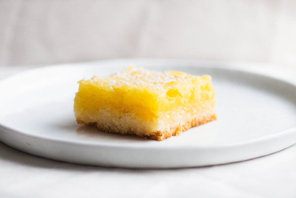 single slice of smitten kitchen whole lemon bar recipe on white plate