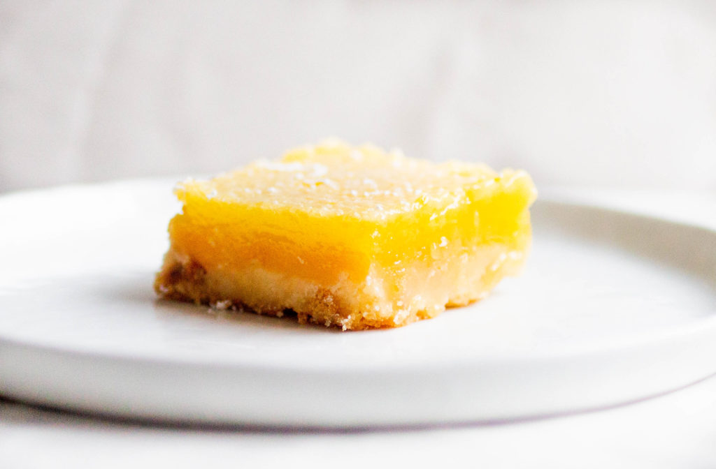 single slice of tartine bakery lemon bars on white plate