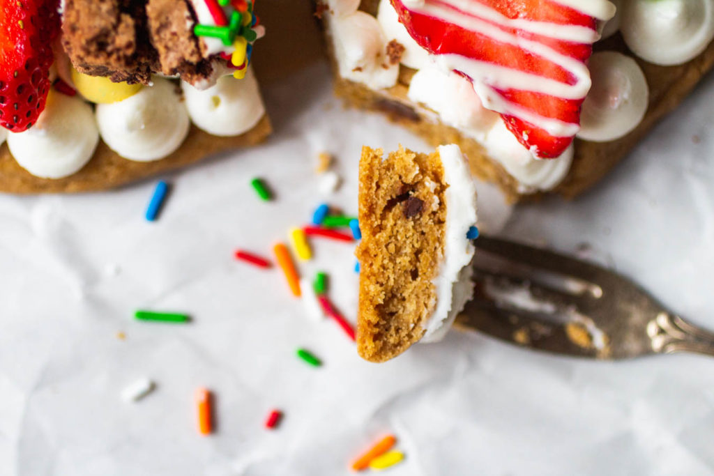 slice of birthday cookie cake with frosting and strawberry