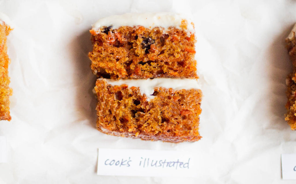 Slice of a doubled layered carrot cake on parchment paper - recipe by cook's illustrated