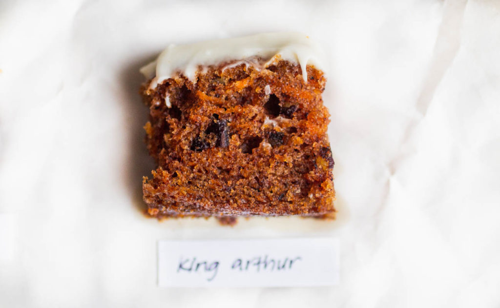 Slice of king arthur carrot cake recipe on parchment paper