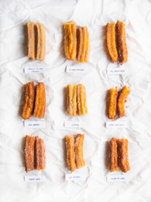9 churros cut in half on a white background