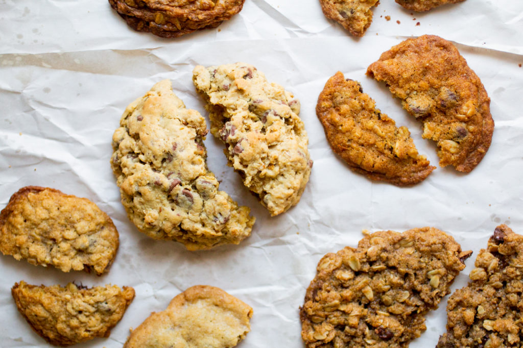 halves of oatmeal cookies on a white sheet