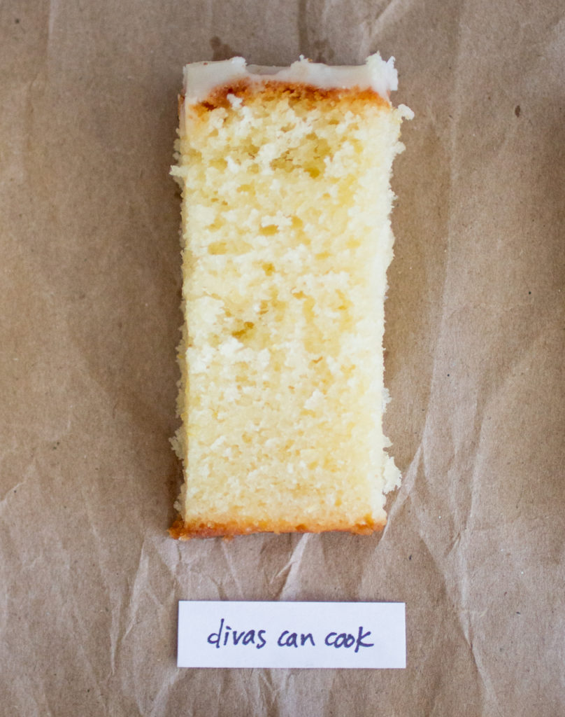 slice of glazed lemon loaf with a white label on a brown paper background