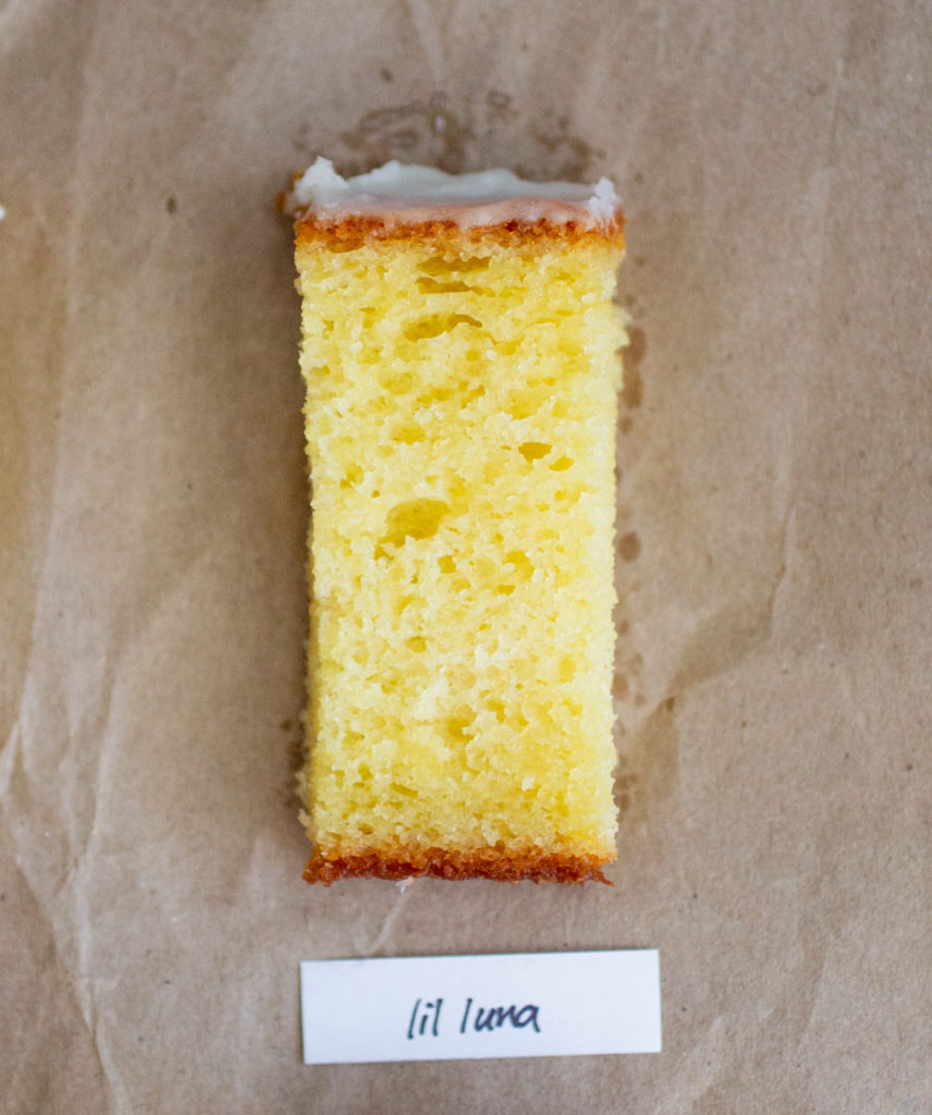 slice of glazed lemon cake with a white label on a brown paper background