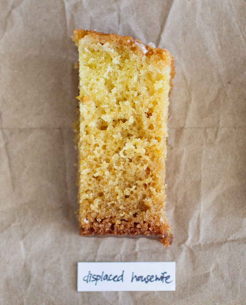 slice of glazed lemon cake with a white label on a brown paper background