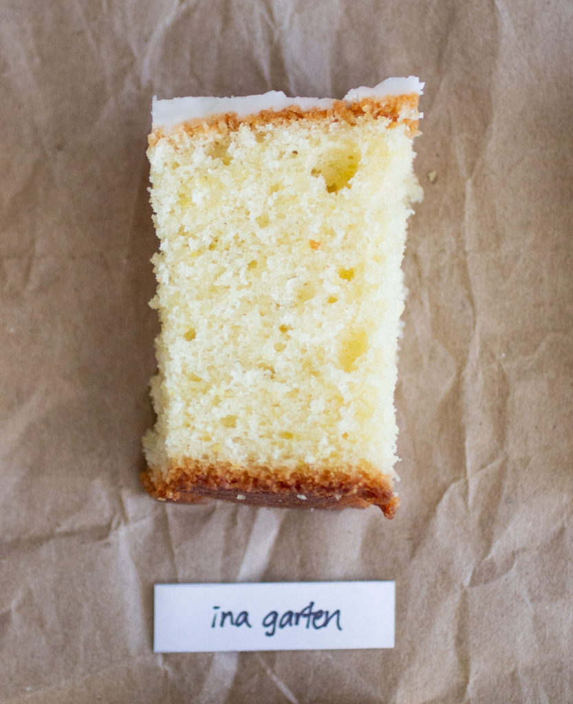 slice of glazed lemon cake with a white label on a brown paper background