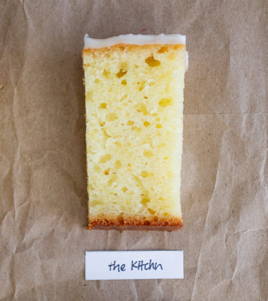 slice of glazed lemon cake with a white label on a brown paper background