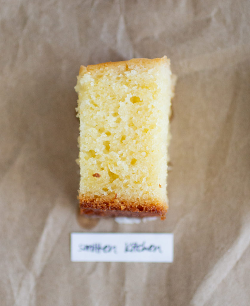 slice of glazed lemon cake with a white label on a brown paper background