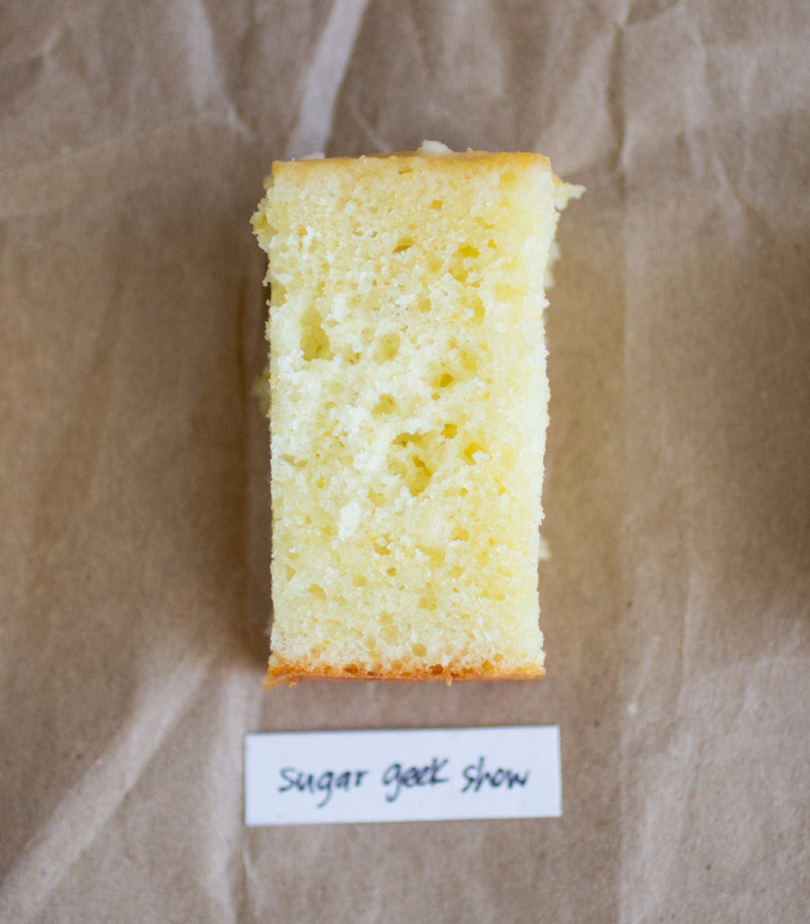 slice of glazed lemon cake with a white label on a brown paper background