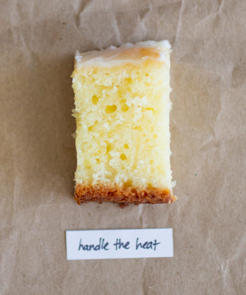 slice of glazed lemon cake with a white label on a brown paper background