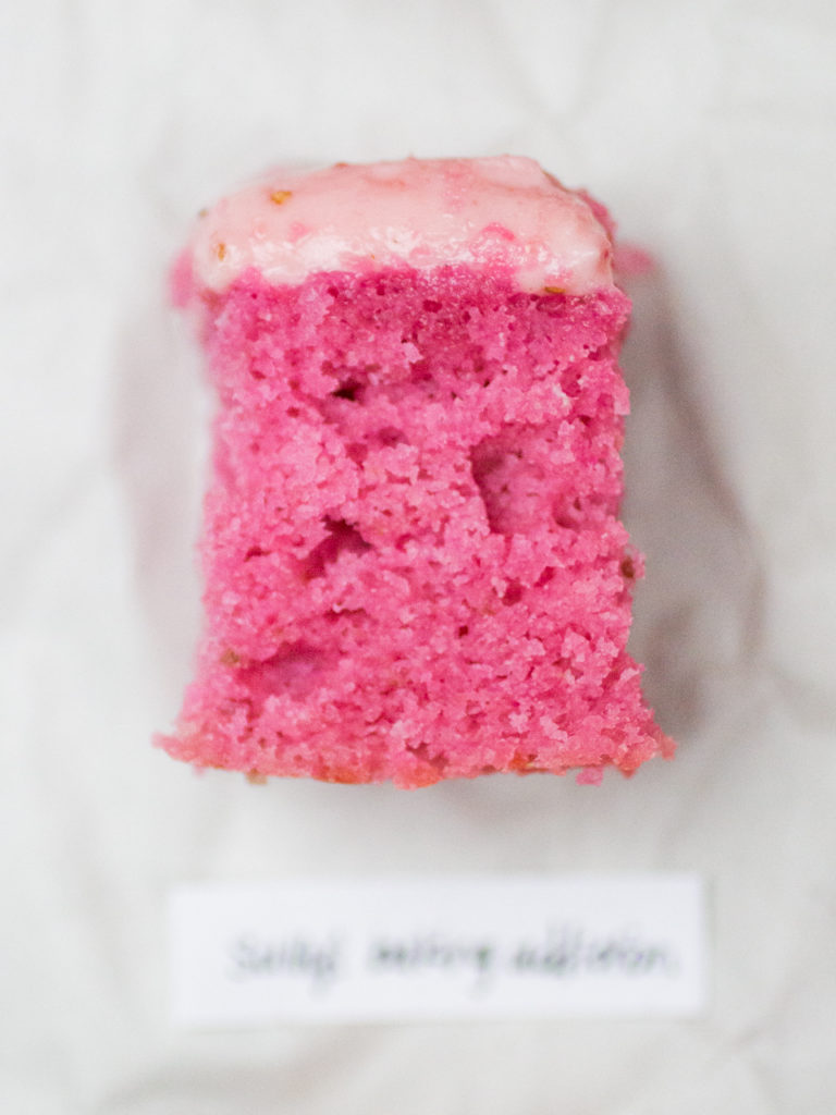 Slice of pink strawberry cake by Sally's Baking Addiction on white parchment
