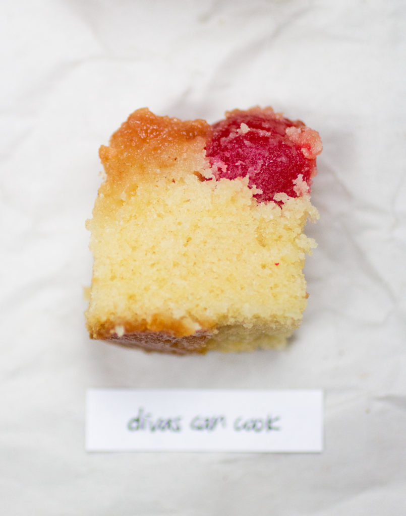 chunk of pineapple upside down cake on a crinkled white paper background