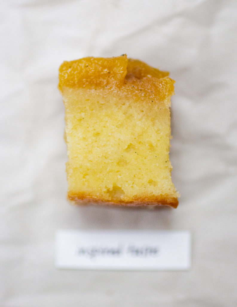 chunk of pineapple upside down cake on a crinkled white paper background