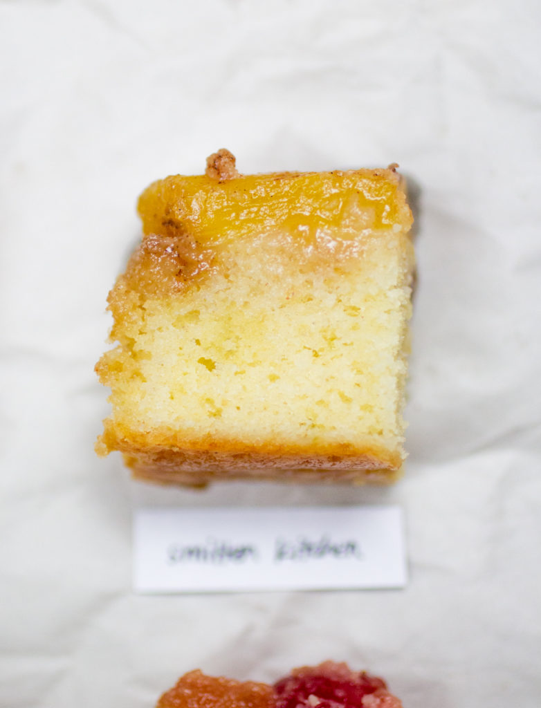 chunk of pineapple upside down cake on a crinkled white paper background