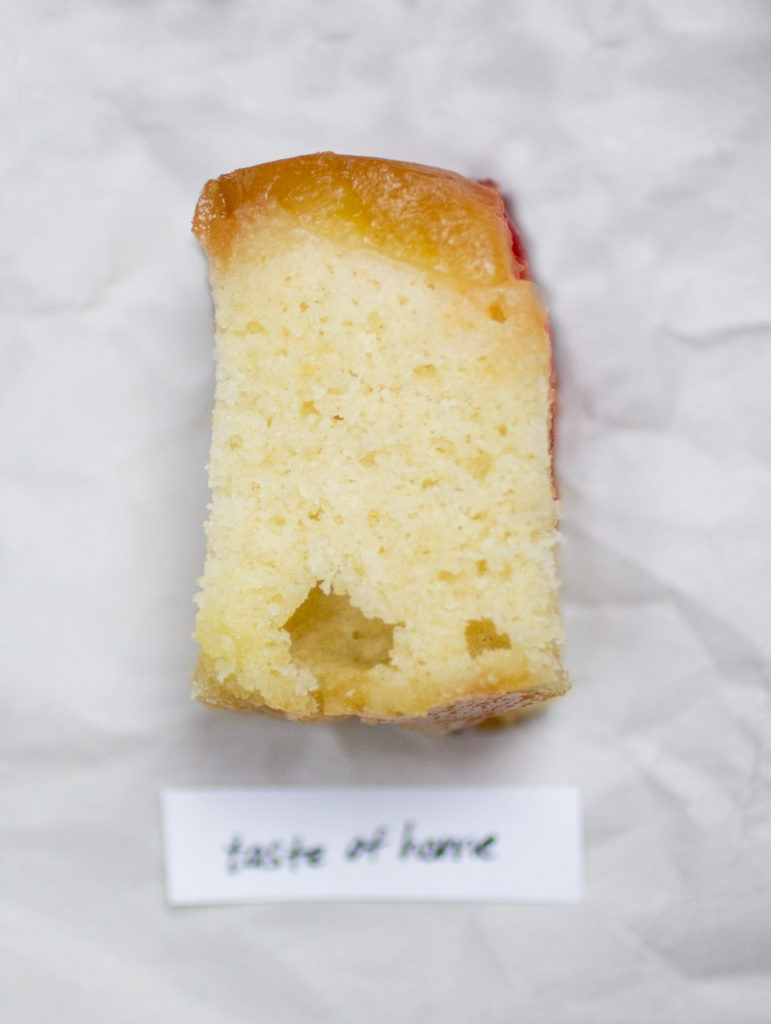 chunk of pineapple upside down cake on a crinkled white paper background