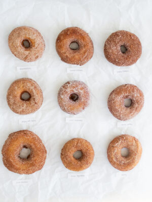 9 apple cider donuts on a white background