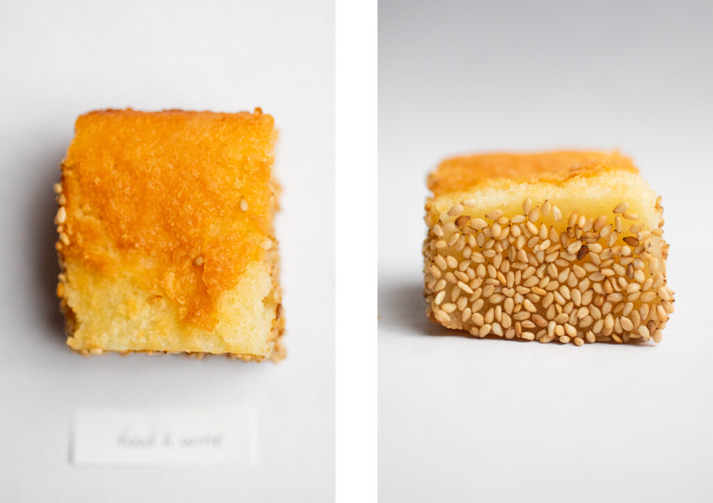 a square of mochi with sesame seeds on a white background