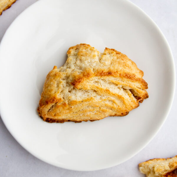 a golden scone on a white plate