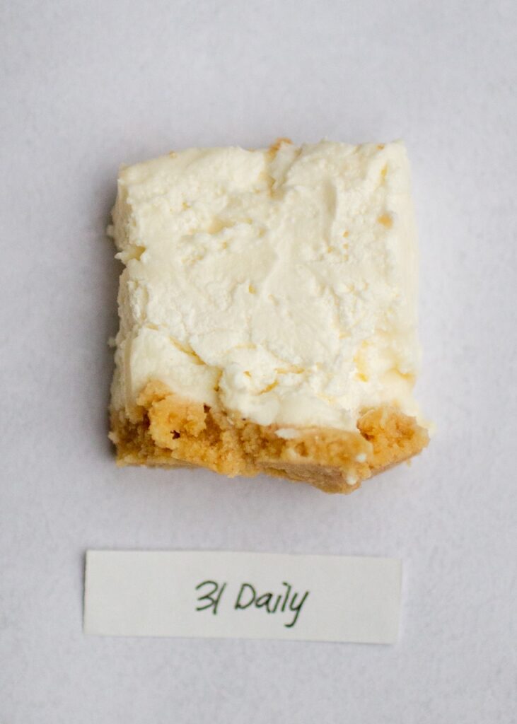 a square of 31 daily no-bake cheesecake on a gray background.