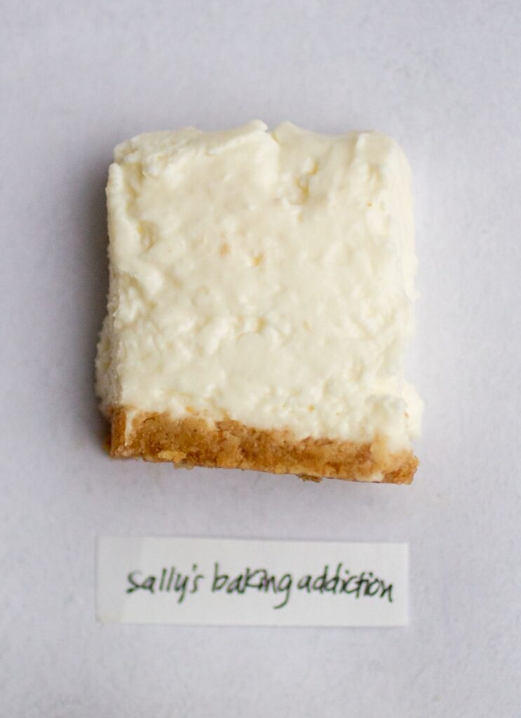 a square of no-bake cheesecake on a gray background