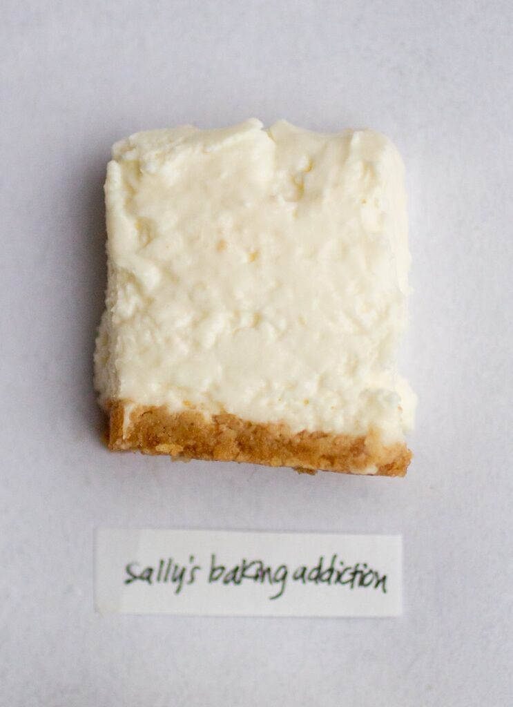 a square of no-bake cheesecake on a gray background.