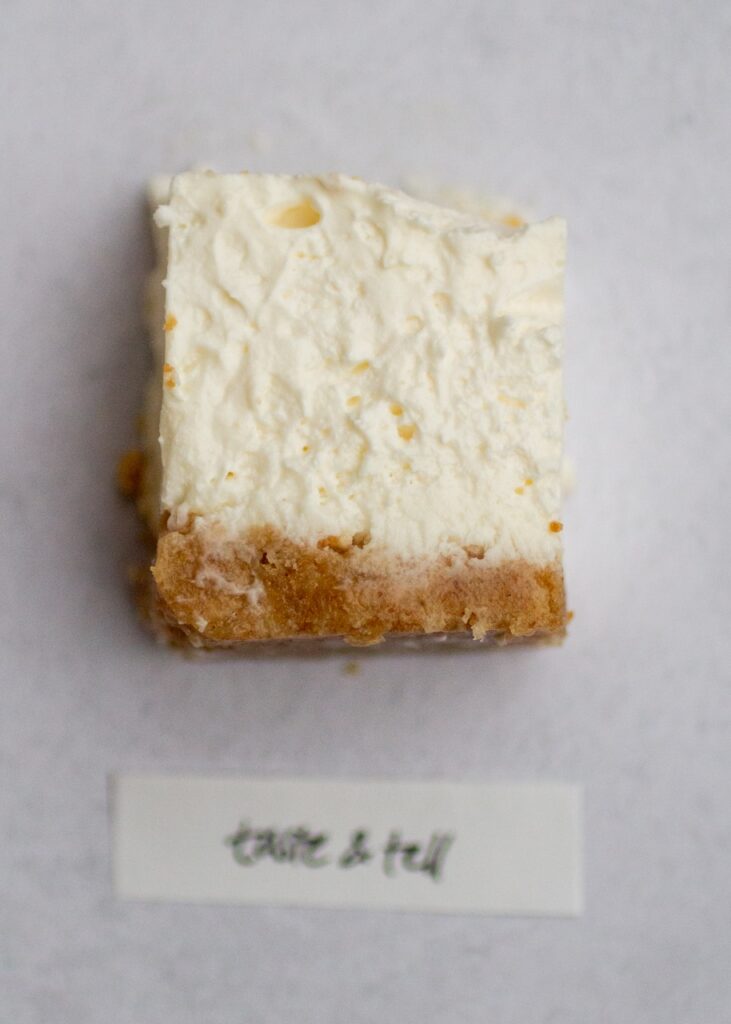 taste and tell no-bake cheesecake on a gray background.