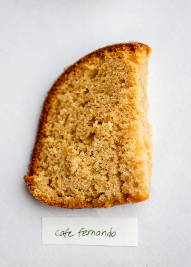 a slice of apple cake with the label "cafe fernando" on a gray background