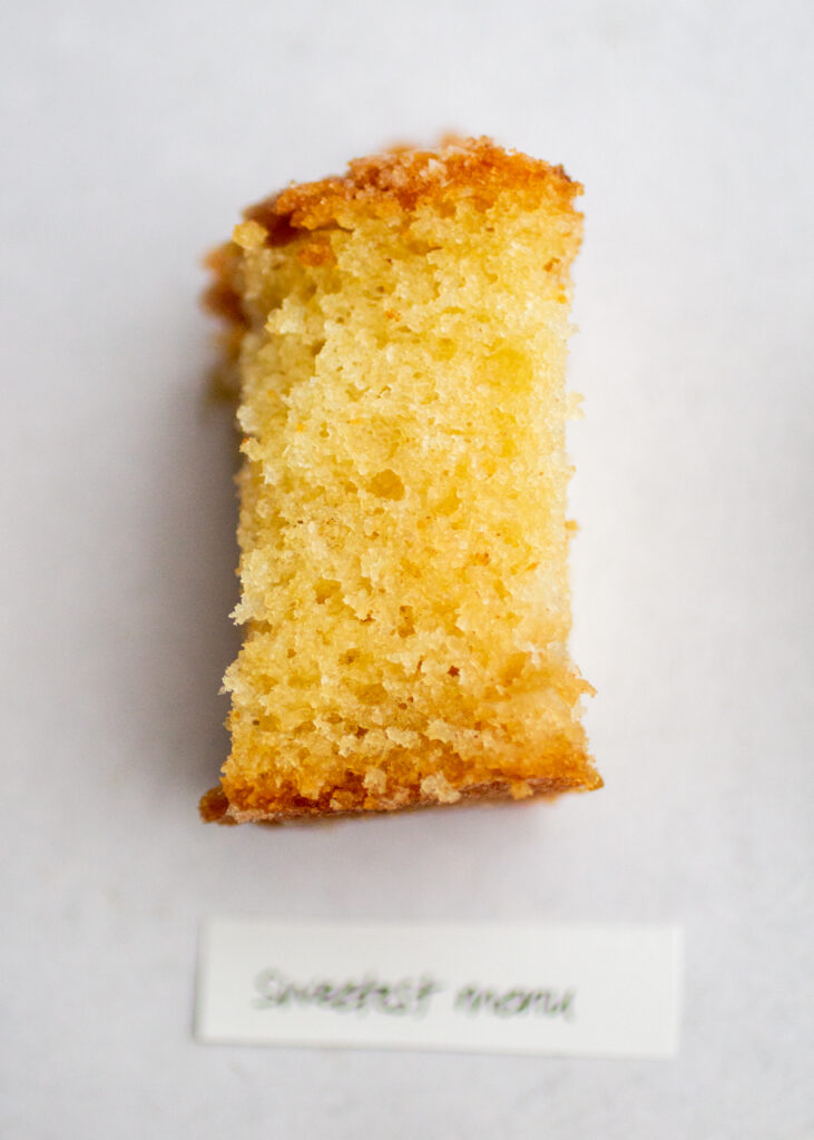 a slice of apple cake with the label \"sweetest menu\" on a gray background.