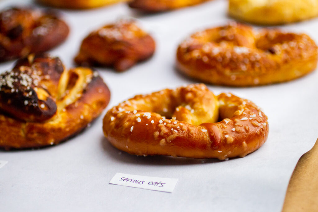 a close up on a soft pretzel with the label \"serious eats.\"