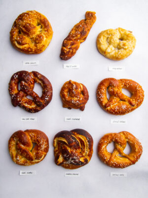 9 different soft pretzels on a gray background