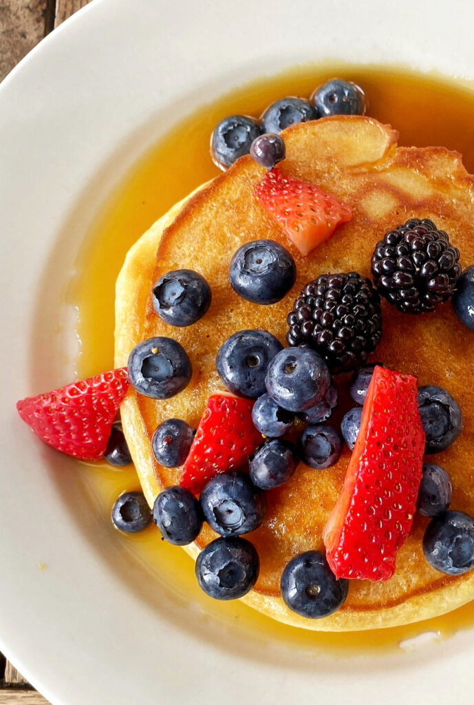 A close up of a pancake topped with berries from La Bergamote.