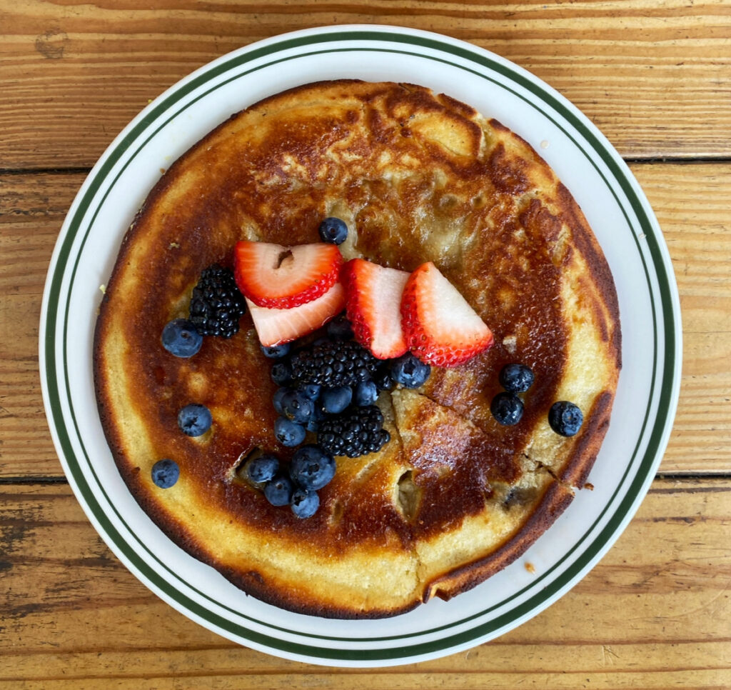 Pancakes topped with strawberries and blueberries from Mud Spot NYC.