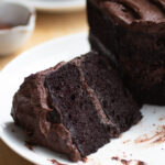 a slice of double chocolate black bean cake on a white plate.