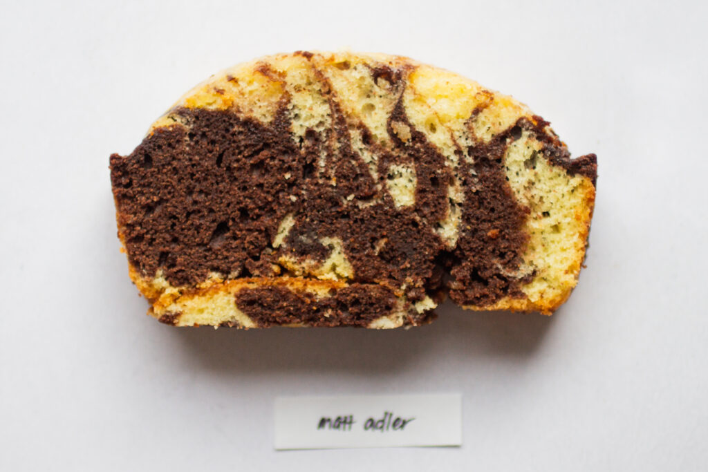 a slice of matt adlard marble cake on a white background.