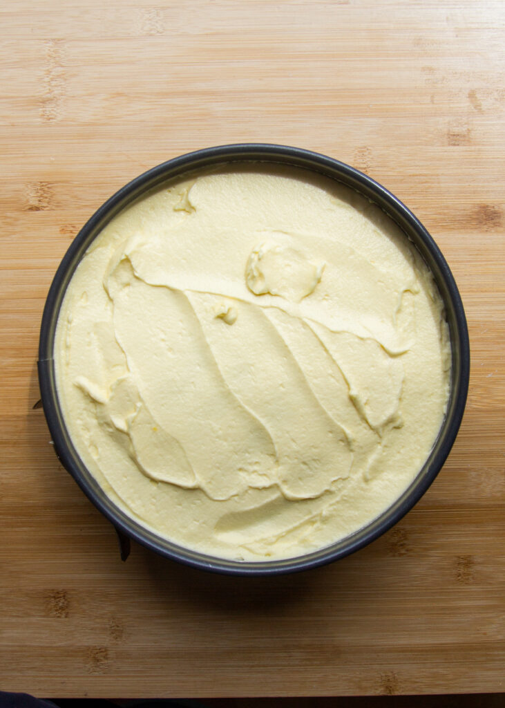 A layer of mascarpone cream in a round pan.