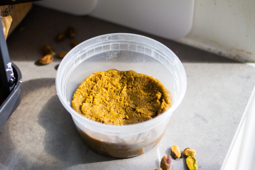 pistachio paste in a clear deli container.