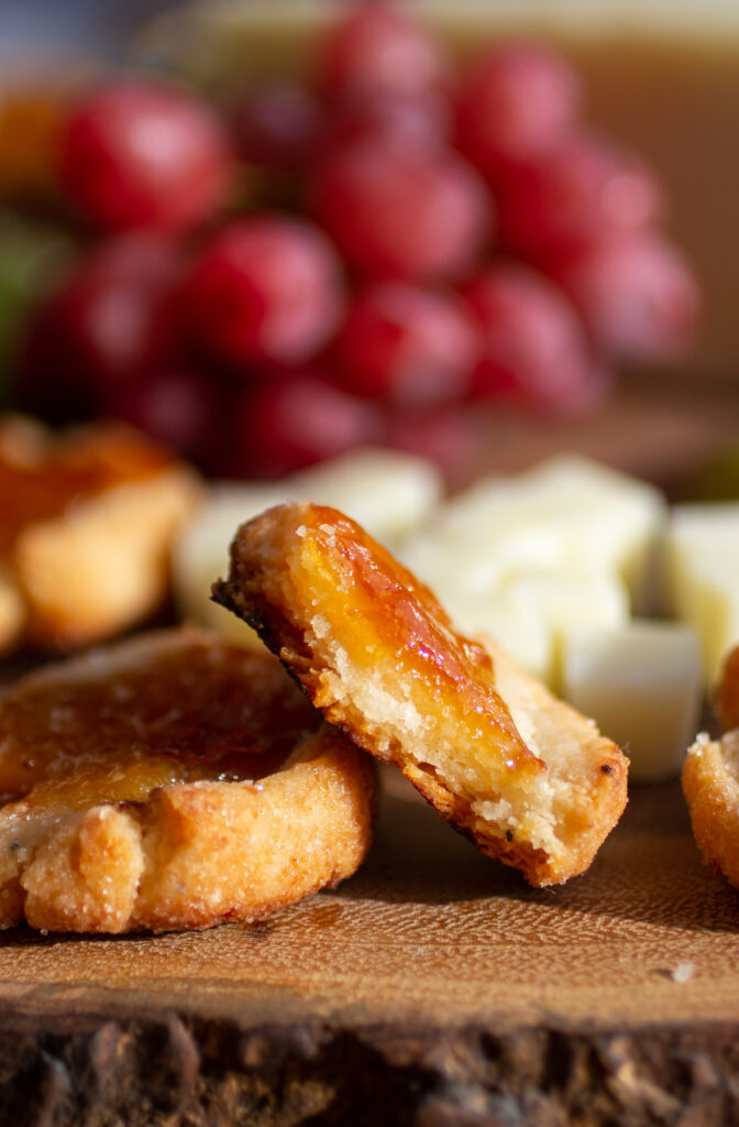Half of a cheesy thumbprint cookie.
