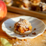 An apple pie cookie on a white plate.