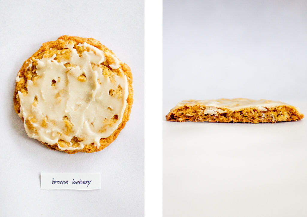 Broma Bakery\'s iced oatmeal cookie on a gray background.
