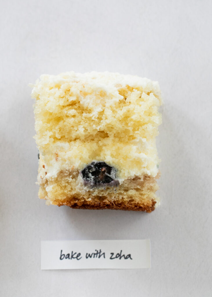 A slice of berry chantilly cake with the label "Bake with Zoha."