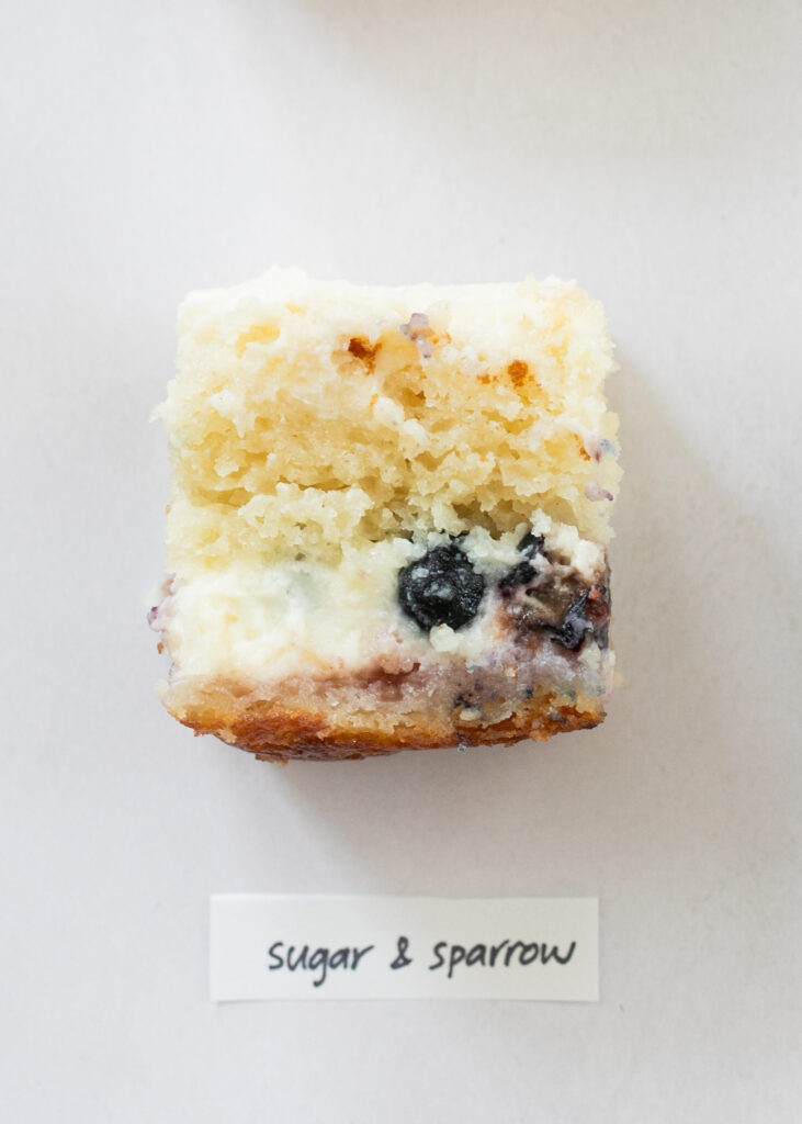 A slice of berry chantilly cake with the label "Sugar and Sparrow."