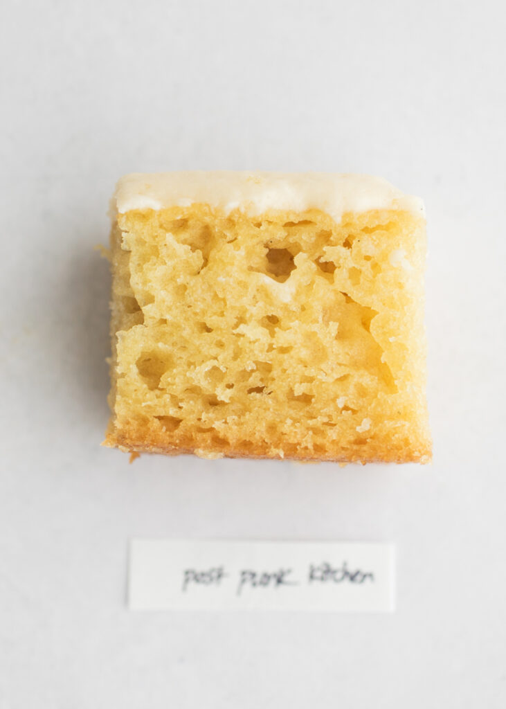 A slice of vegan vanilla cake with a label that says "Post Punk Kitchen."